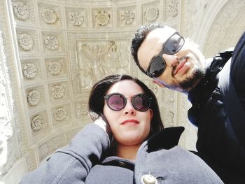 Low angle portrait of man and woman wearing sunglasses