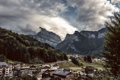 Scenic view of townscape and mountains against sky