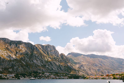 Scenic view of sea and mountains against sky