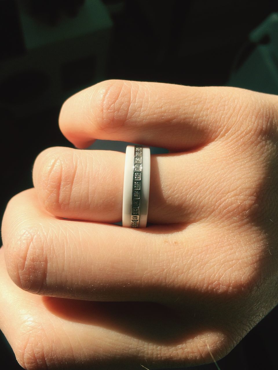 person, part of, human finger, indoors, close-up, cropped, holding, unrecognizable person, ring, focus on foreground, personal perspective, showing, high angle view, palm, studio shot, selective focus, detail