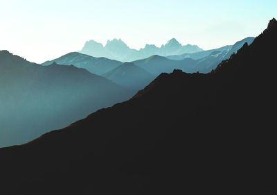 Scenic view of silhouette mountains against clear sky