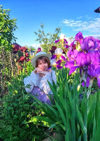 Portrait of woman standing by plants