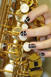 Cropped image of woman hand playing saxophone