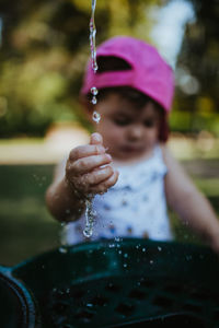 Close-up of baby girl playing with water in sink