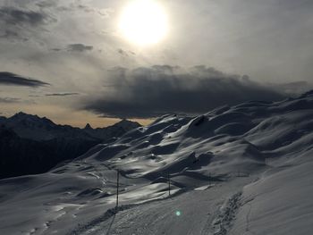 Scenic view of snow mountains against sky during sunset