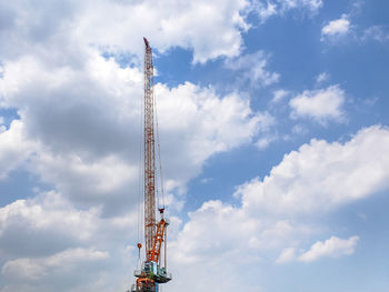 Low angle view of crane against sky