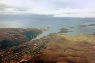 Aerial view of landscape against cloudy sky