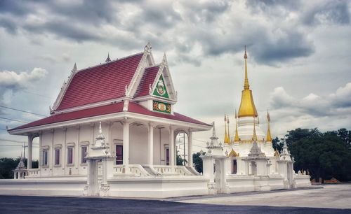 View of temple building against cloudy sky