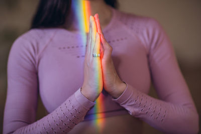 Midsection of woman practicing yoga