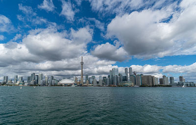 Panoramic view of sea and buildings against sky