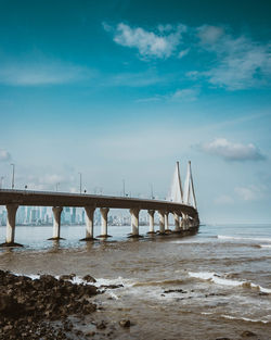 Bridge over sea against sky