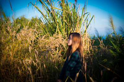 Young woman standing in field