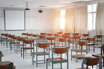 Empty chairs and tables in classroom