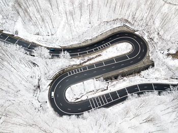 High angle view of road amidst snow covered trees