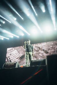 Panoramic shot of man standing on illuminated stage