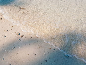 Close-up of waves on beach against sky