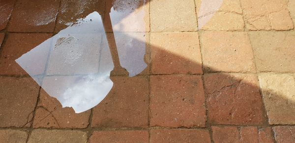 High angle view of broken glass on footpath