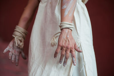 Midsection of woman hands covered with paint