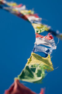 Close-up of hand against clear blue sky