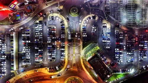 Aerial view of cars parked at parking lot during night