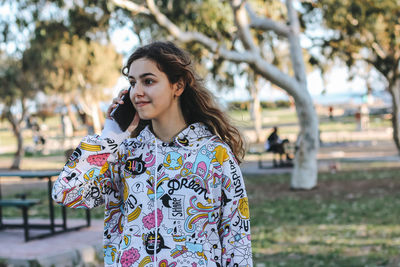 Pretty teenager girl talking by phone 
