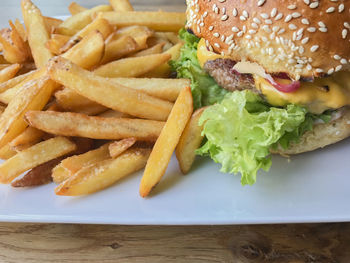 Close-up of burger and vegetables on plate