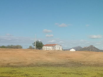 House on field against sky