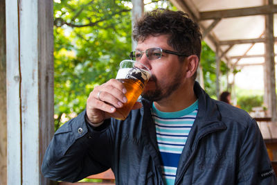 Close-up of man drinking beer