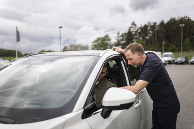 Man trying car in car dealership