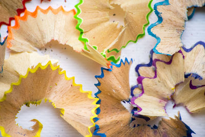 Close-up of multi colored pencil shavings on table