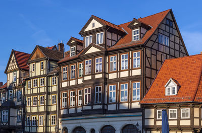 Low angle view of buildings against blue sky