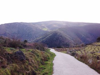 Country road leading towards mountains