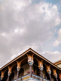 Low angle view of building against cloudy sky