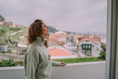 Young woman standing against blurred background