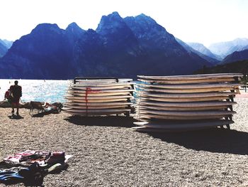 Man on beach against mountains