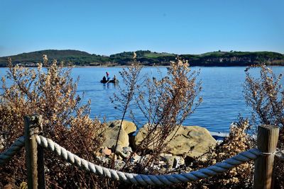 Scenic view of lake against clear blue sky