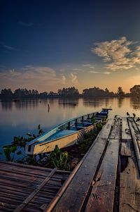 Scenic view of river against sky at sunset