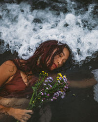 High angle view of woman lying down on plant