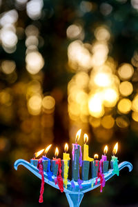 Close-up of illuminated candles against blurred background