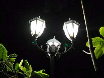 Low angle view of lamp post at night