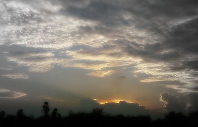 Scenic view of silhouette trees against sky at sunset