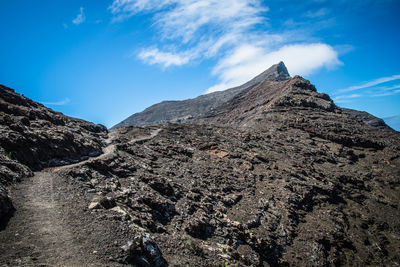 Low angle view of rock formations against sky