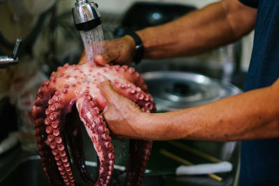 Midsection of man preparing food in kitchen