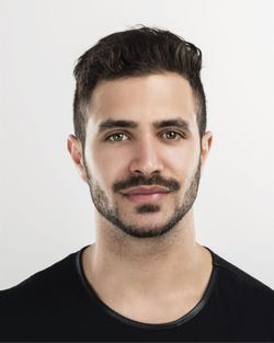 Portrait of young man against white background