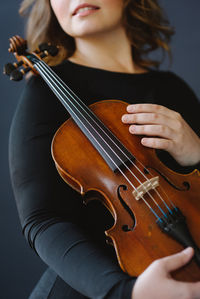 Midsection of woman with violin 