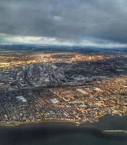 Aerial view of sea against cloudy sky