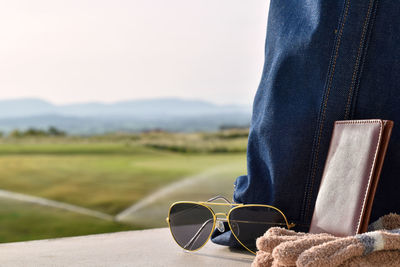 Close-up of sunglasses on skateboard