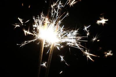 Low angle view of firework display at night