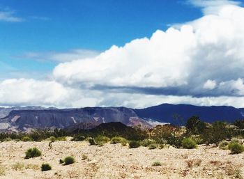 Scenic view of mountains against cloudy sky