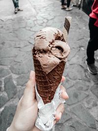 Cropped image of hand holding ice cream cone